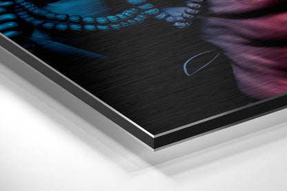 Angled close-up view of brushed aluminium Dibond wall art showing layered edge construction with blue and purple glowing text on black surface.