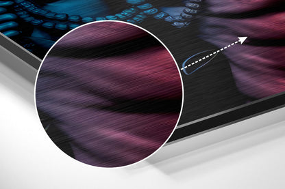 Close-up magnified detail of brushed aluminium surface showing purple and burgundy streaked texture with directional lines.