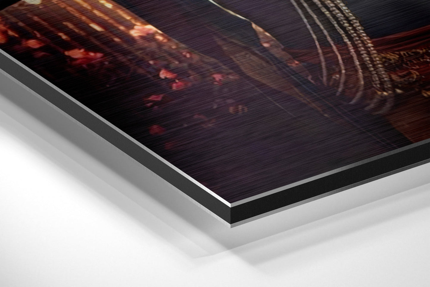Close-up angled view of layered Dibond panel showing brushed aluminum edge and white backing layers beneath printed Radha Krishna artwork.