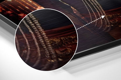 Close-up detail of brushed aluminium surface showing dark red and gold tones with horizontal texture patterns and shadow effects.