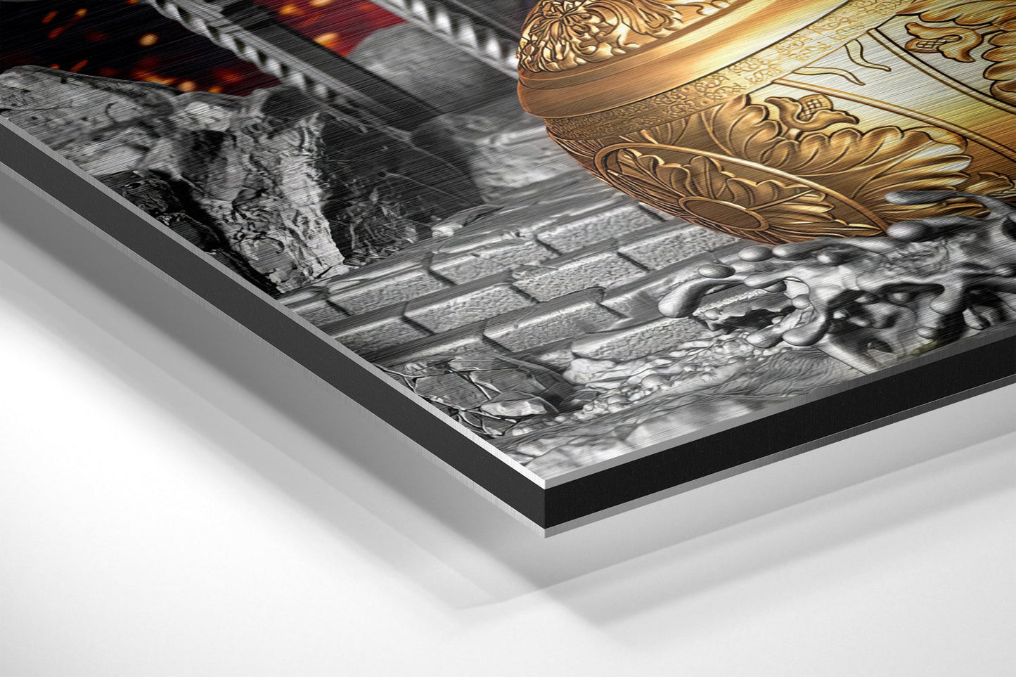 Angled perspective view of Hanuman wall art showing black aluminium frame, white mount, and gold ornamental detail on brushed metal surface.