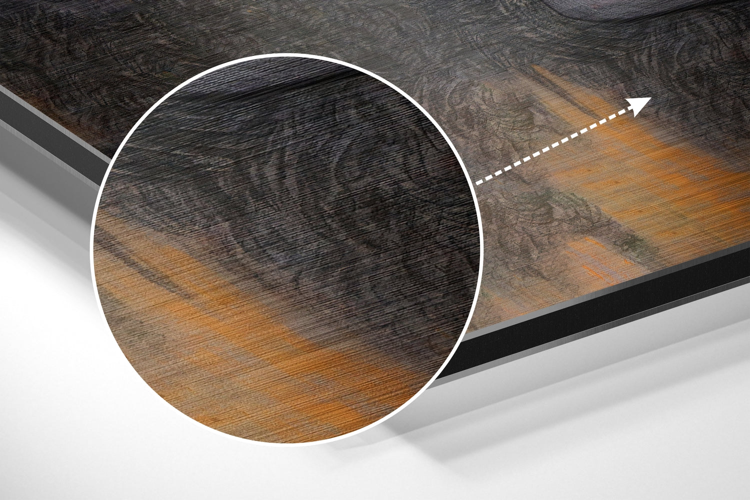 Close-up circular detail of brushed aluminium Dibond wall art showing wood grain texture with black and golden brown tones and directional arrow indicator.