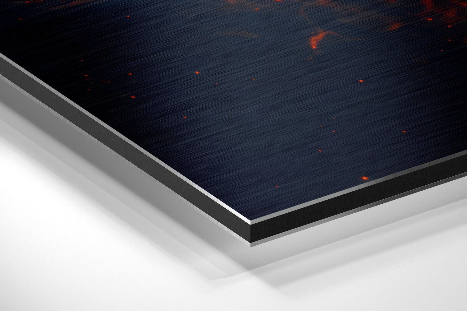 Close-up angled view of layered Fire Lion Dibond wall art showing brushed dark blue and orange surface with gray and white aluminum backing edges.