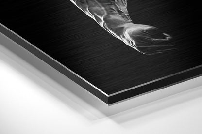 Close-up angled view of layered brushed aluminum and white mounting board edges of black and white motivational wall art.