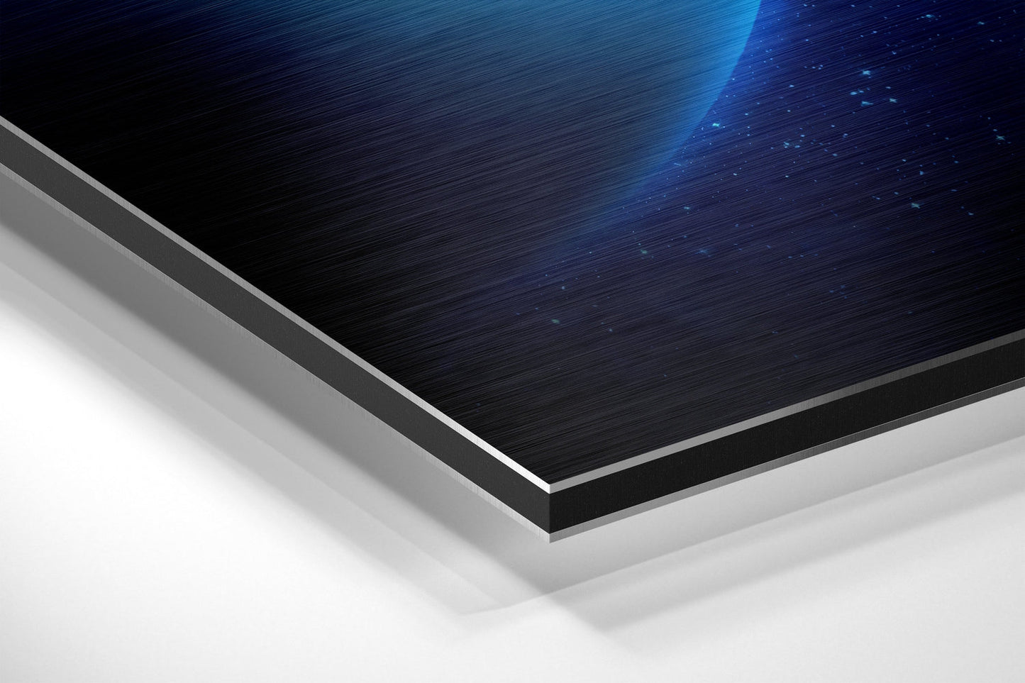 Angled close-up view of layered Uranus Brushed Aluminium Dibond showing blue digital light effect on dark brushed metal surface with silver edge detail.