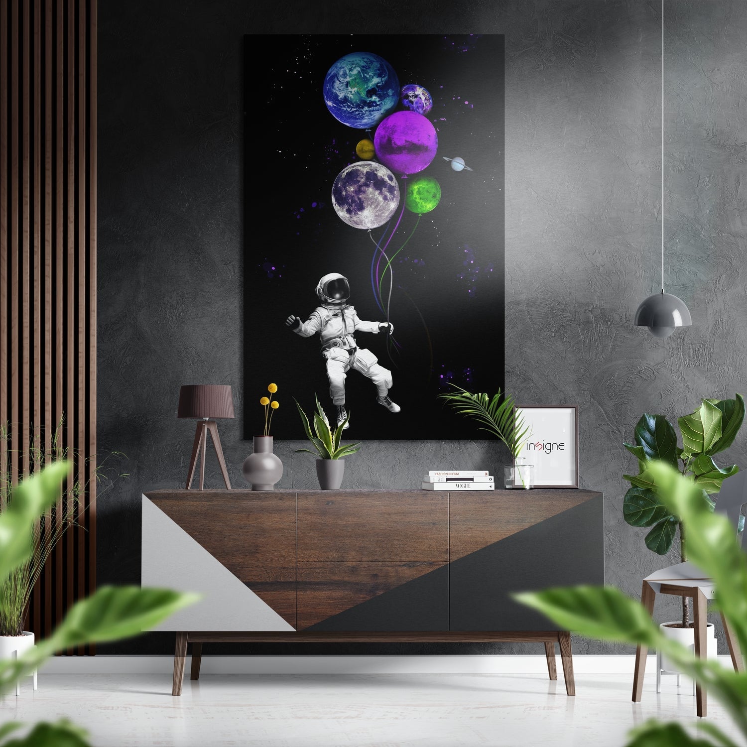 Modern room setting with astronaut holding colorful planet balloons displayed above wooden console table with plants and decor.