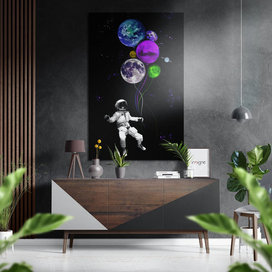 Modern room setting with astronaut holding colorful planet balloons displayed above wooden console table with plants and decor.