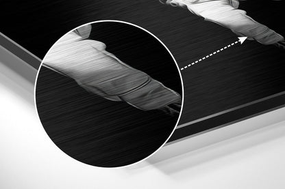 Close-up detail of brushed aluminum surface showing textured finish and white circular magnified section highlighting material grain pattern.