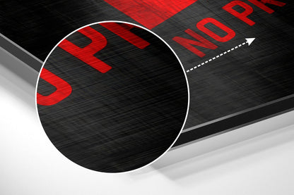 Close-up angled view of brushed aluminum wall art with red "SLOW" and "PROGRESS" text on black and gray surface with white circle detail.