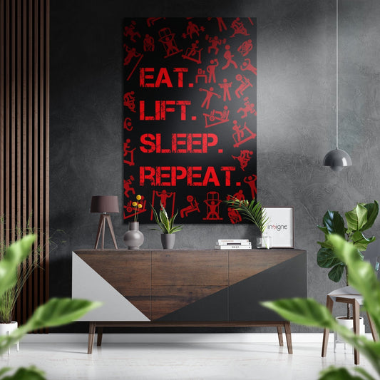 Red and black brushed aluminium wall art displaying "Eat. Lift. Sleep. Repeat." text with fitness icons, mounted above wooden sideboard in modern interior.
