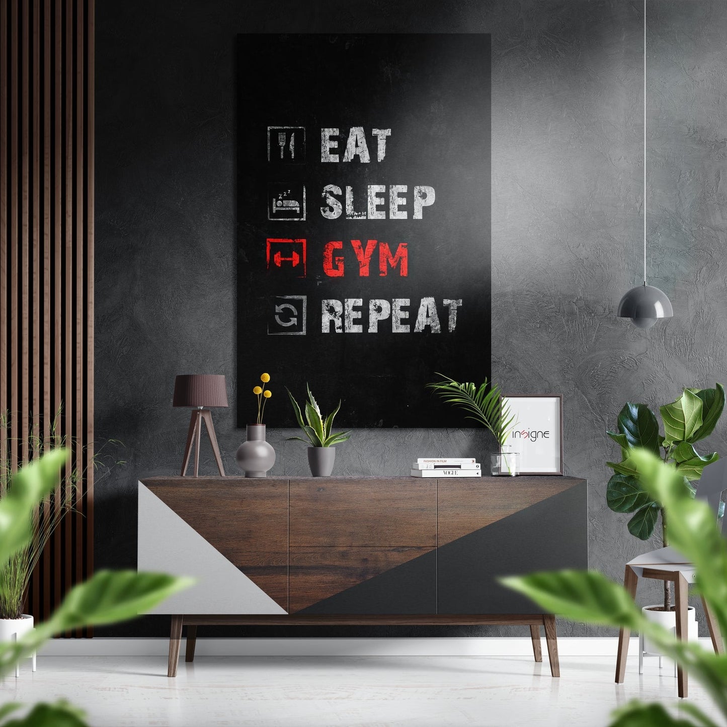 Modern gym room with "Eat Sleep Gym Repeat" brushed aluminum wall art in white and red text above wooden console table.