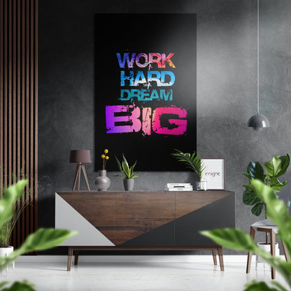 Colorful "Work Hard Dream Big" wall art in blue, cyan, and magenta displayed above a wooden console table in a modern interior setting.