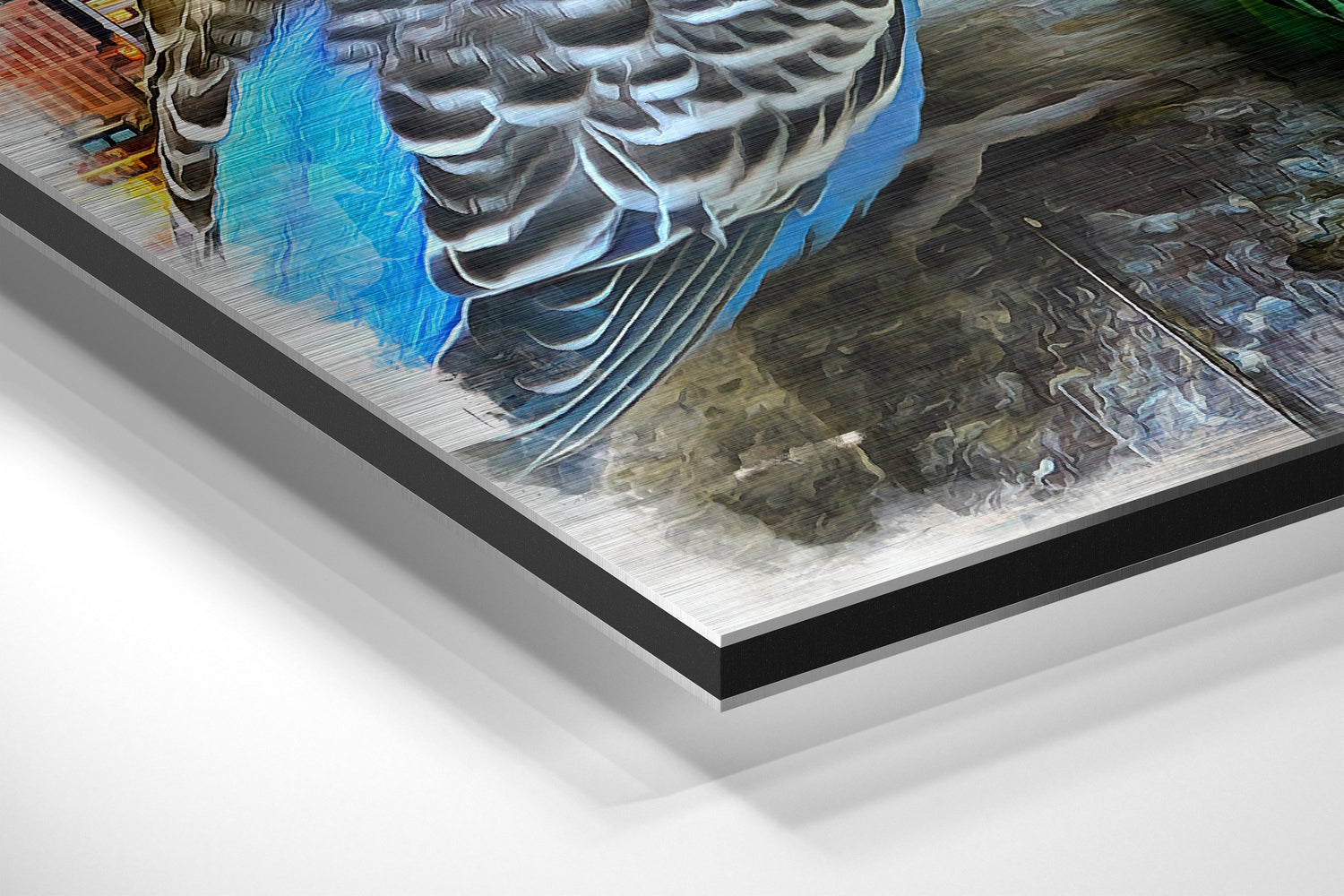 Close-up angled view of brushed aluminium Dibond wall art showing layered edge construction with blue and grey tones in the artwork.