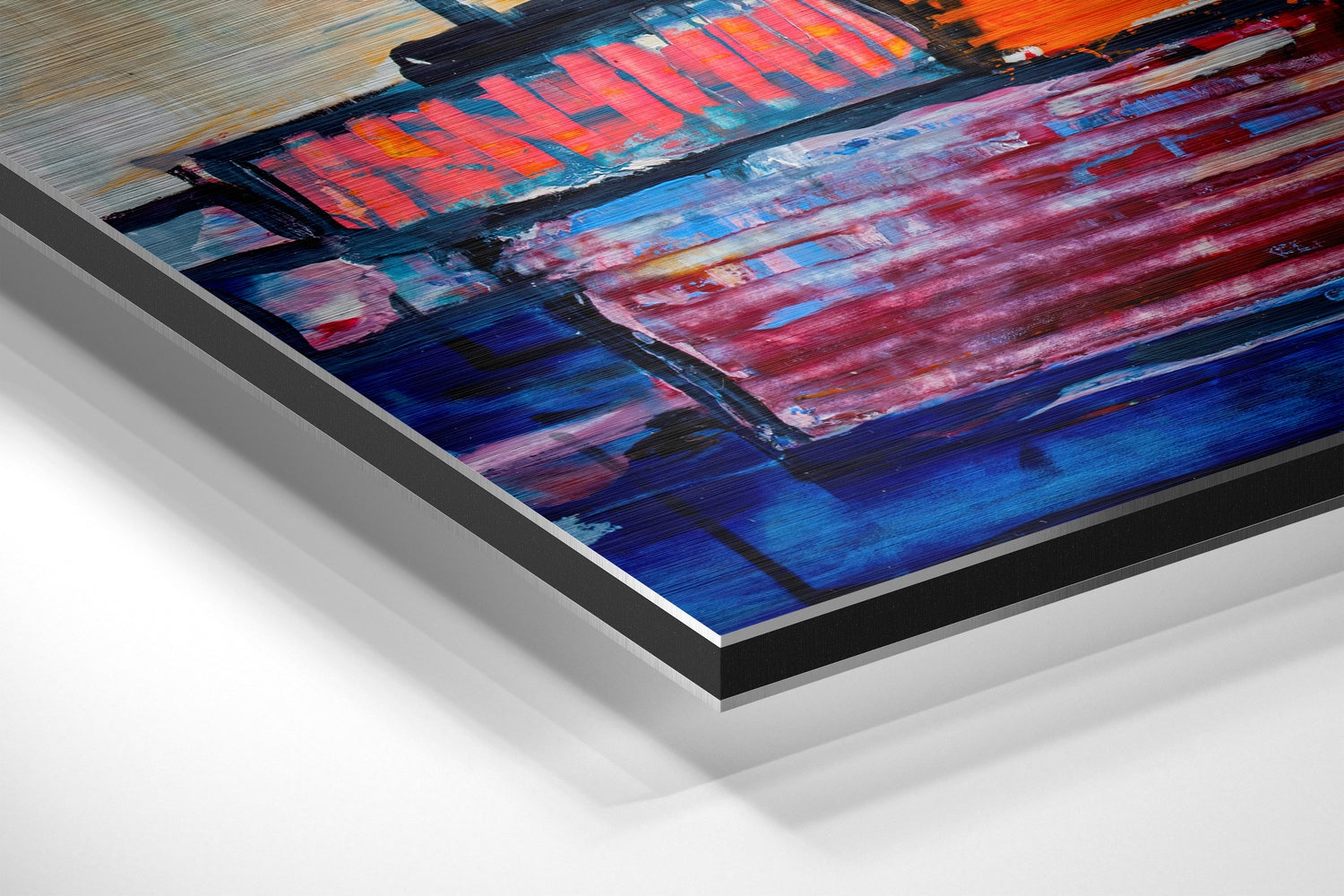 Angled close-up of brushed aluminium Dibond wall art with vibrant red, blue, and orange painted boat imagery and layered edge detail.