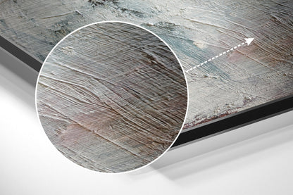 Close-up detail of brushed aluminum surface showing fine linear texture patterns in silver and gray tones with directional arrow indicator.