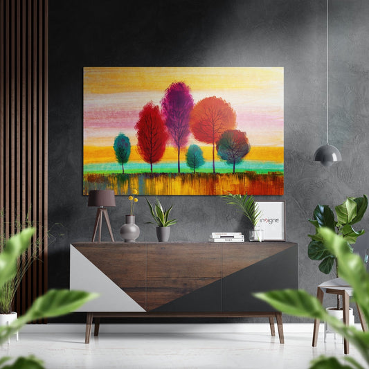 Colorful abstract tree artwork in vibrant reds, purples, and oranges displayed above a wooden dresser in a modern interior setting.