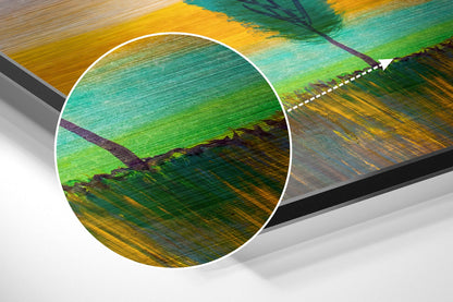 Close-up detail of brushed aluminium wall art showing multicolored horizontal paint strokes in green, yellow, teal, and purple tones.