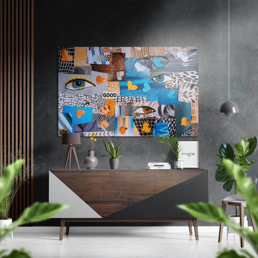 Colorful patchwork wall art featuring eyes, geometric patterns, and hearts in blue, orange, and black mounted above a wooden console table in a modern interior.
