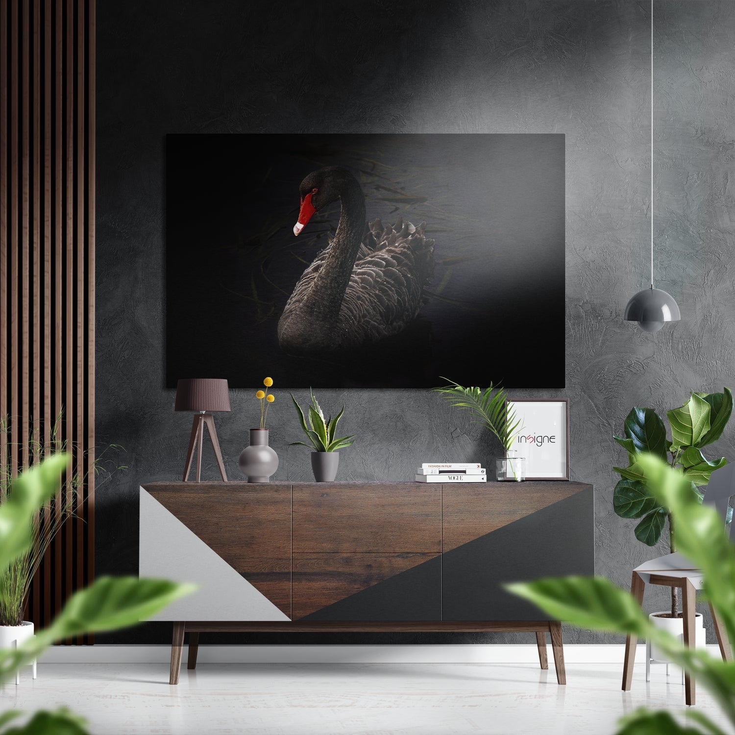 Black swan with red head displayed on wall above wooden console table in modern interior with plants and pendant light.
