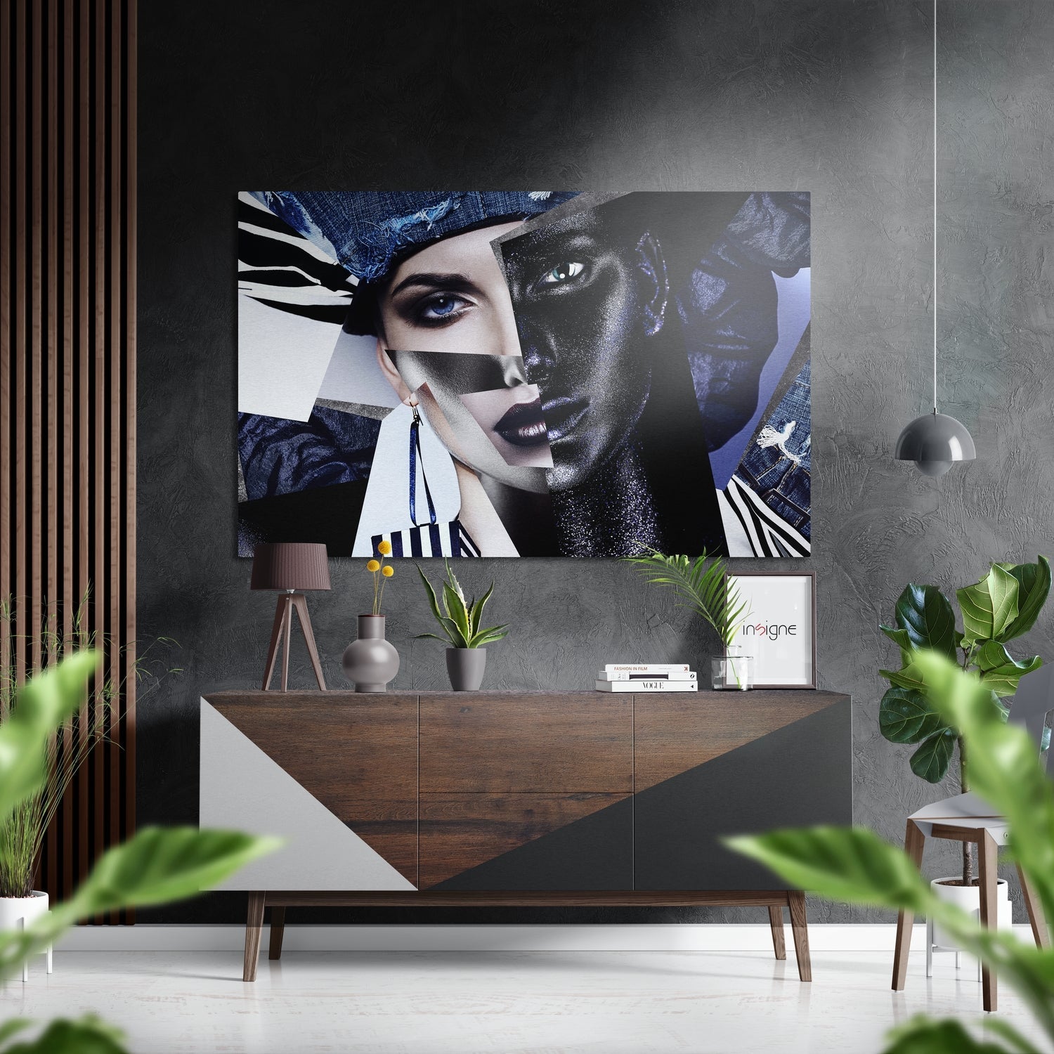 Modern interior with brushed aluminum wall art featuring abstract split faces in blue, black, and white tones mounted above wooden console table with plants and pendant lamp.