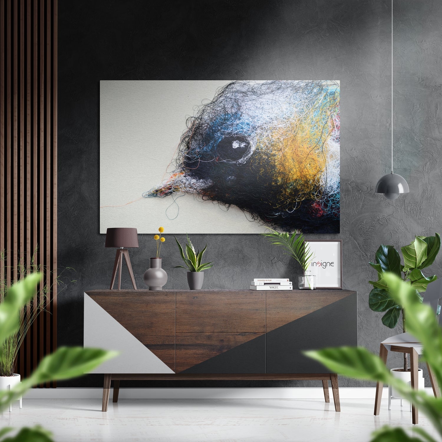 Modern interior featuring abstract bird head artwork in black, blue, and gold tones mounted above wooden console table with décor and plants.