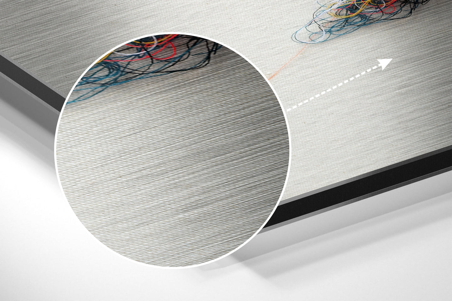 Close-up detail of brushed aluminium surface texture with multicolored electrical wires visible at top edge.