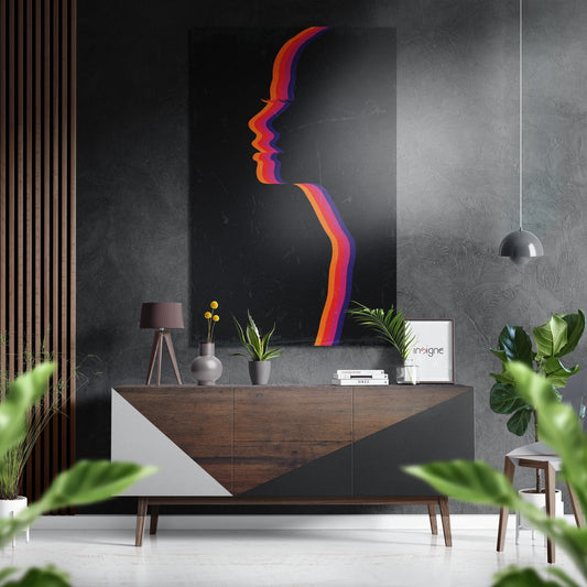 Colorful layered profile silhouette wall art in red, orange, and purple on black Dibond displayed above wooden dresser in modern interior.