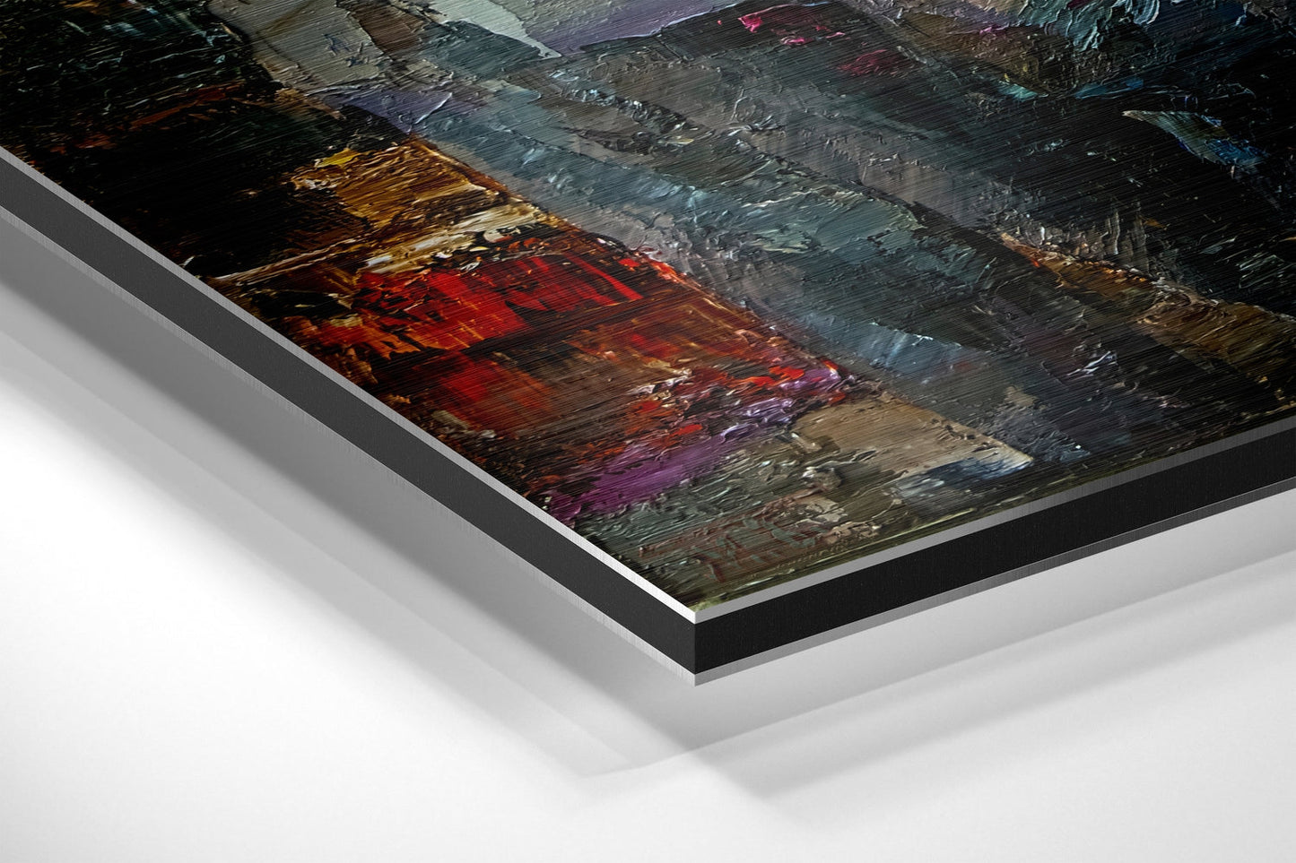 Angled perspective view of brushed aluminium dibond wall art with abstract multicolored painted texture in reds, golds, blues, and purples.