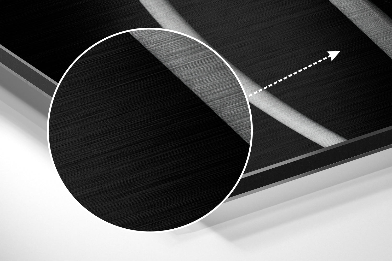 Abstract close-up of brushed aluminium wall art showing white circle outline and directional arrow on layered textured surfaces.