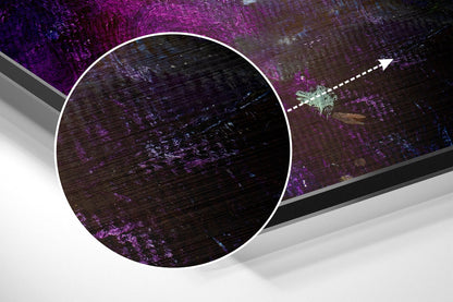 Close-up detail of brushed aluminium wall art showing purple and dark textured surface with magnified circular view and directional arrow indicator.