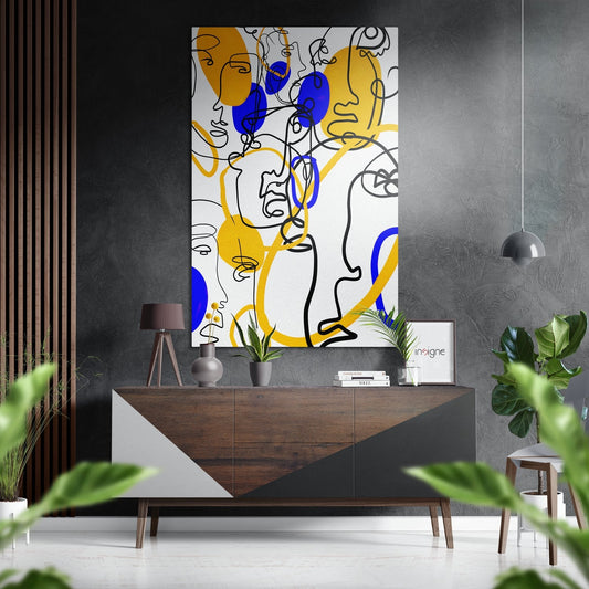 Modern living room interior featuring abstract line art with blue and yellow faces on white wall above wooden credenza.