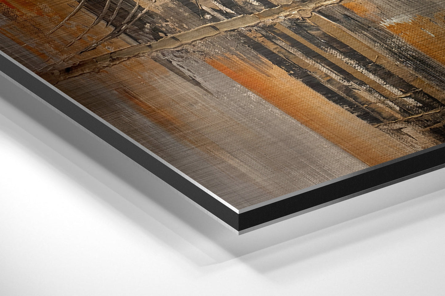 Close-up angled view of brushed aluminum Dibond panel edges showing layered construction with black backing and white core, displaying wood grain texture detail above.