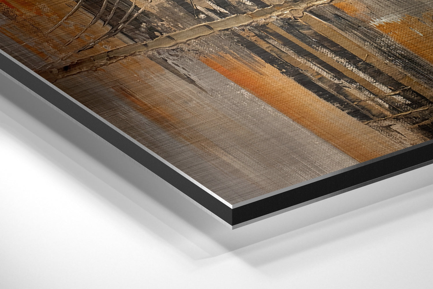 Close-up angled view of brushed aluminum Dibond panel edges showing layered construction with black backing and white core, displaying wood grain texture detail above.