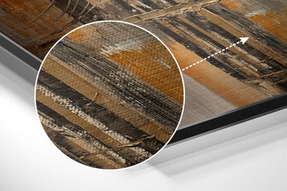 Close-up detail of brushed aluminum dibond surface showing diagonal wood grain texture in brown, tan, and black tones with metallic finish.