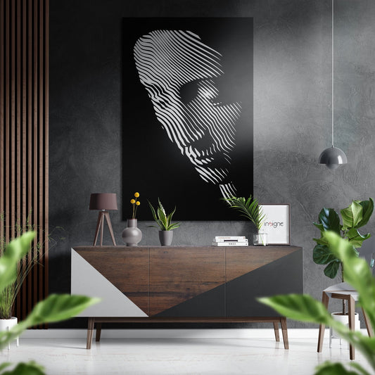 Modern living room with line face wall art displayed above wooden console table with potted plants and decorative objects.