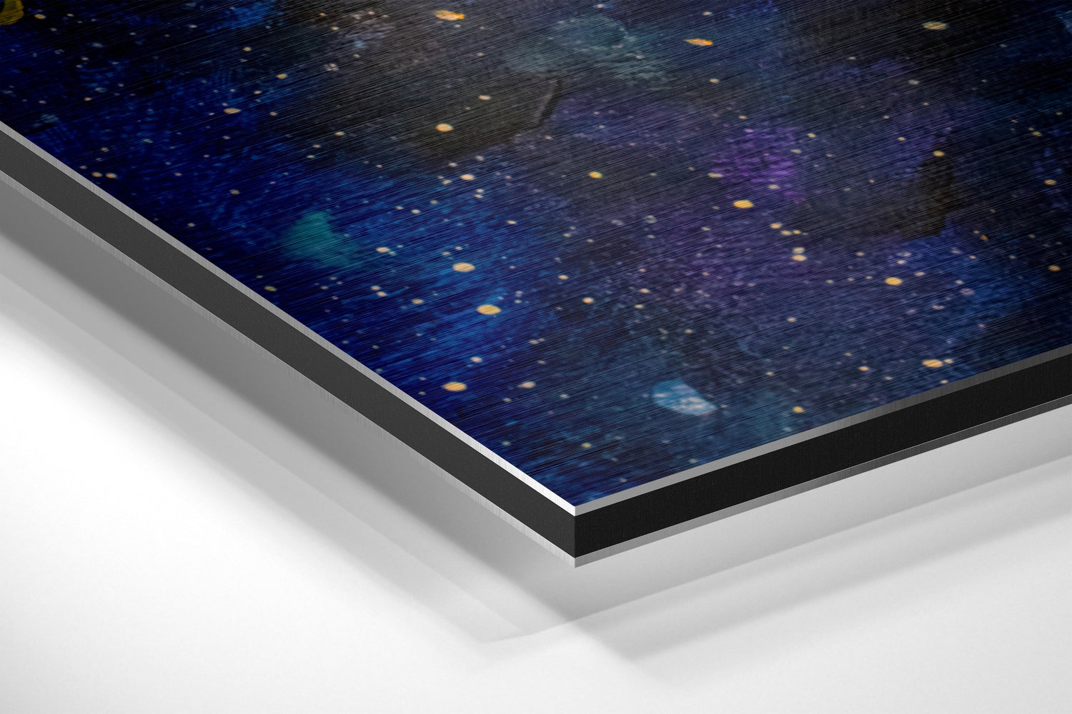 Angled perspective view of Moonfall Dibond wall art showing starry night sky with golden and blue tones, brushed aluminum frame edges visible.