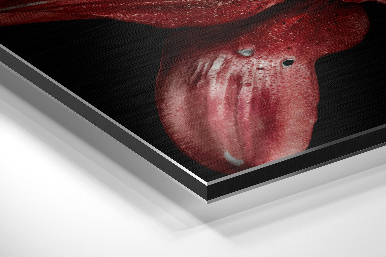 Close-up angled view of red lily flower on brushed aluminum dibond panel with layered edge detail visible.