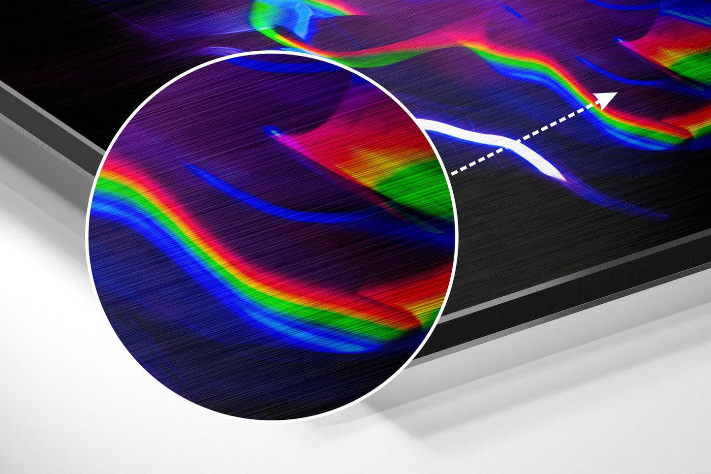White-outlined circular prism dispersing rainbow light spectrum across dark brushed surface with gray shadow.