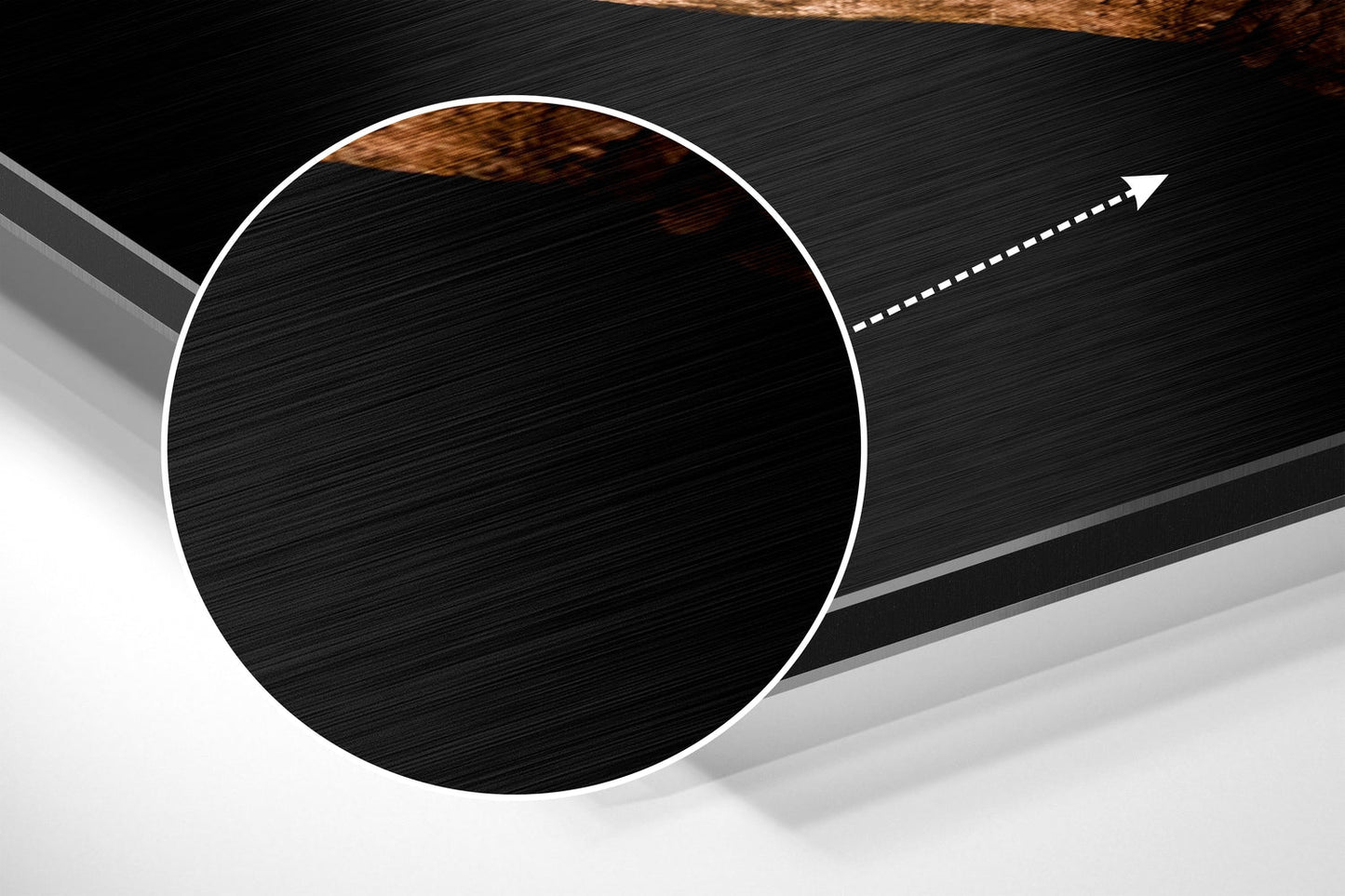 Abstract angled view of brushed black aluminium circular disc with white border and directional arrow on grey background.