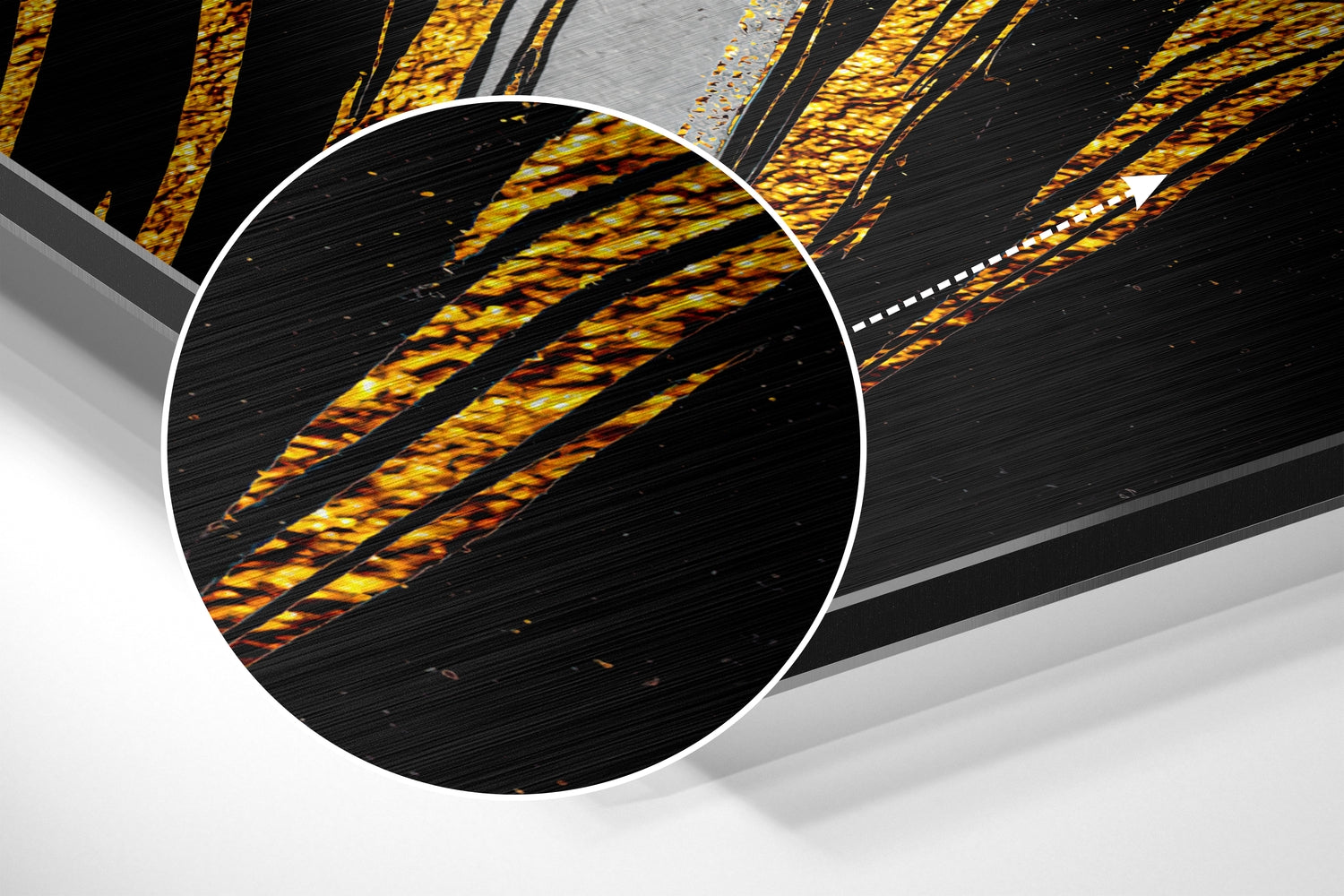 Close-up detail of golden and yellow brushed aluminum surface with diagonal striped texture pattern and black background.