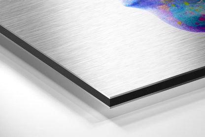 Close-up angled view of brushed aluminum Dibond panel with colorful abstract artwork visible in top right corner.