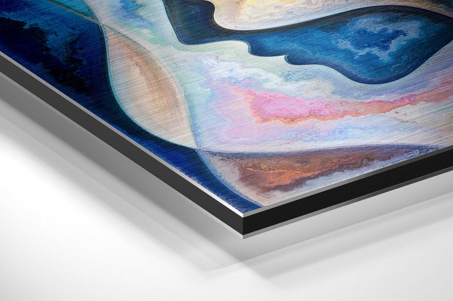Angled view of brushed aluminium Dibond wall art showing blue, pink, and brown layered abstract design with black edge frame.