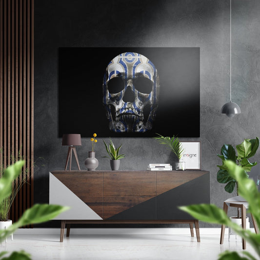 Blue and white patterned skull artwork displayed on dark wall above wooden console table in modern interior setting.