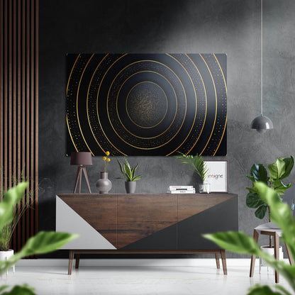 Modern interior with concentric gold and black circles brushed aluminum wall art displayed above a wooden console table with plants and decor.