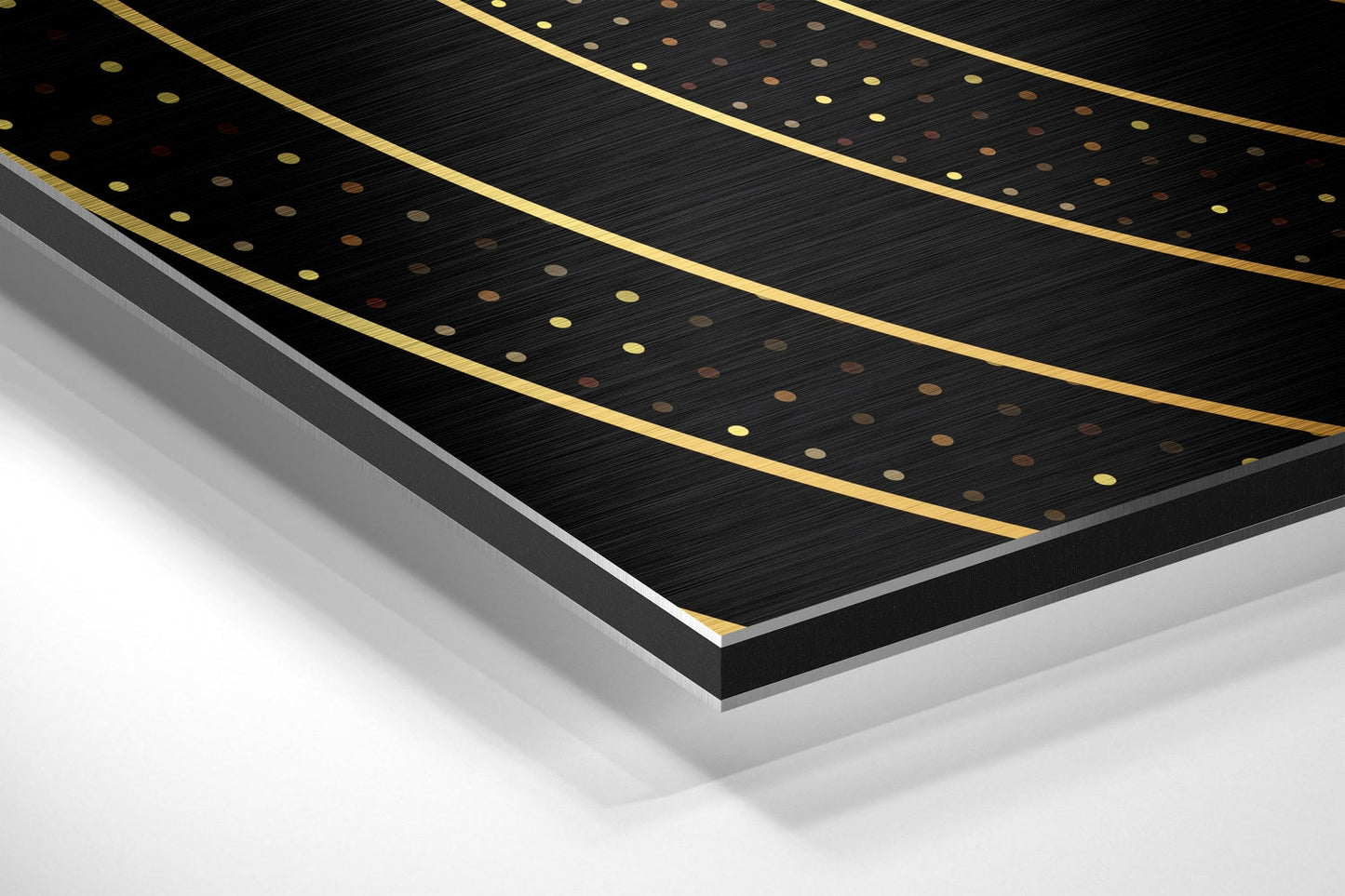 Angled perspective view of black brushed aluminum dibond panel with gold-trimmed curved lines and scattered metallic dots, layered against white background.