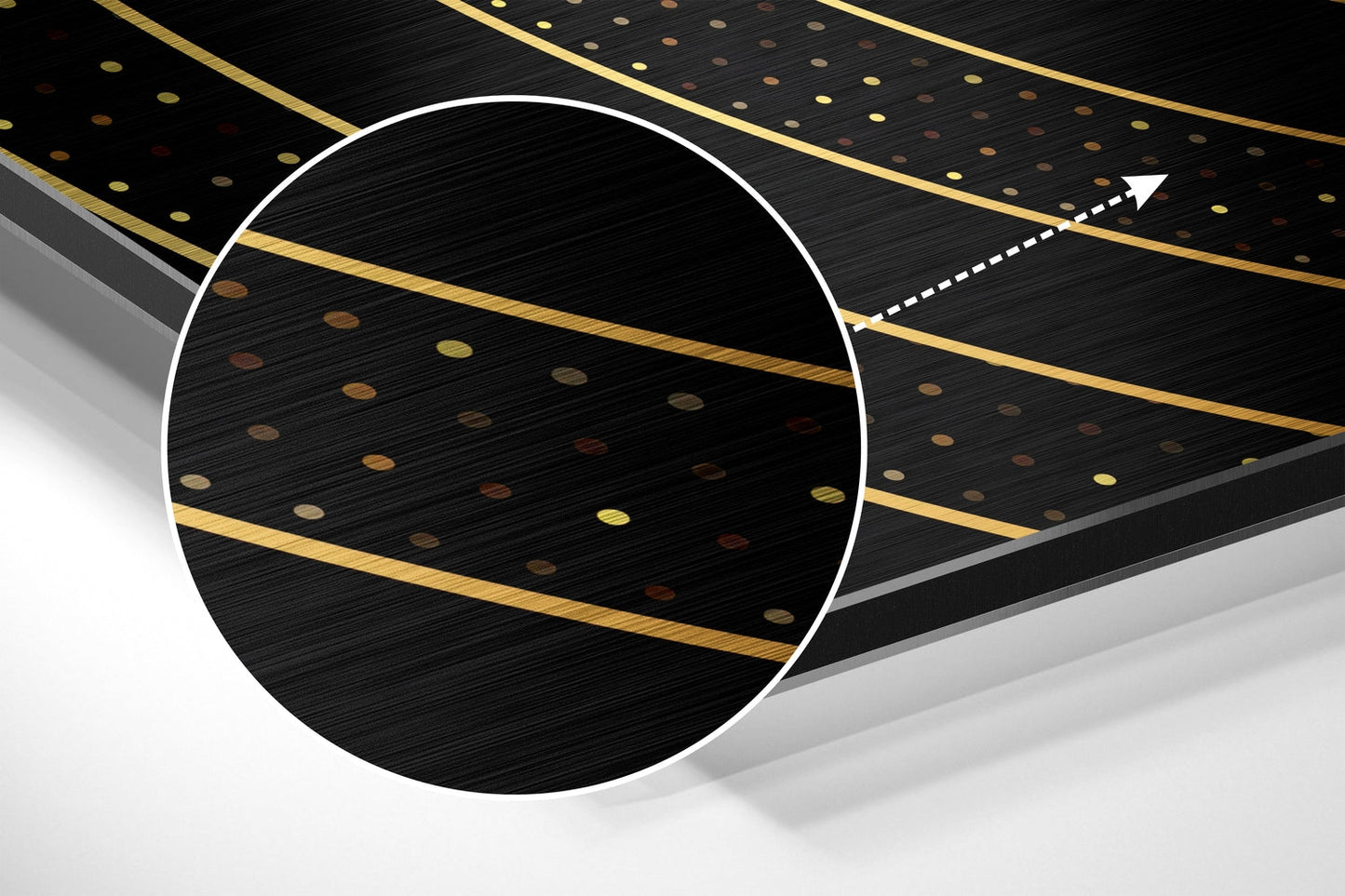 Close-up angled view of brushed aluminum dibond wall art featuring white circle outline with gold and copper dotted pattern on black textured surface.