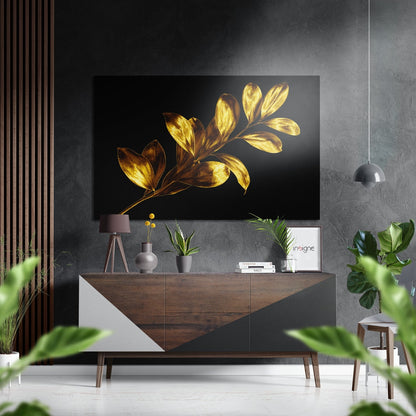 Modern living room with golden leaf artwork displayed above wooden dresser, surrounded by plants and pendant lighting.