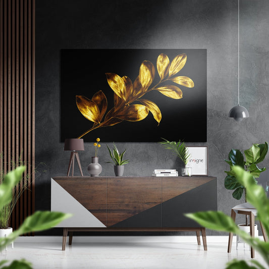 Modern living room with golden leaf artwork displayed above wooden dresser, surrounded by plants and pendant lighting.