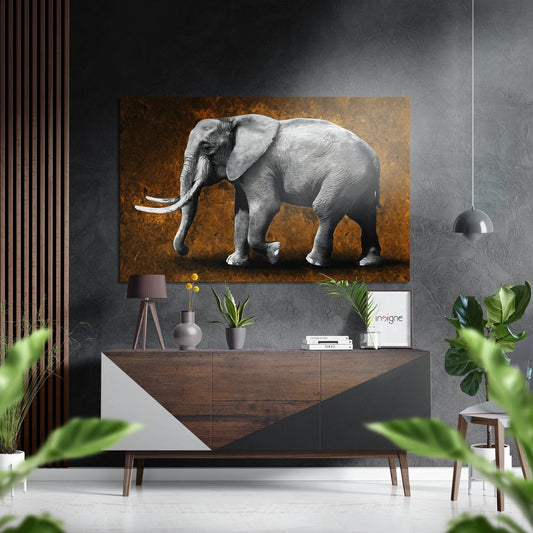 Gray elephant with ivory tusks on amber textured background displayed above mid-century wooden console in modern interior setting.