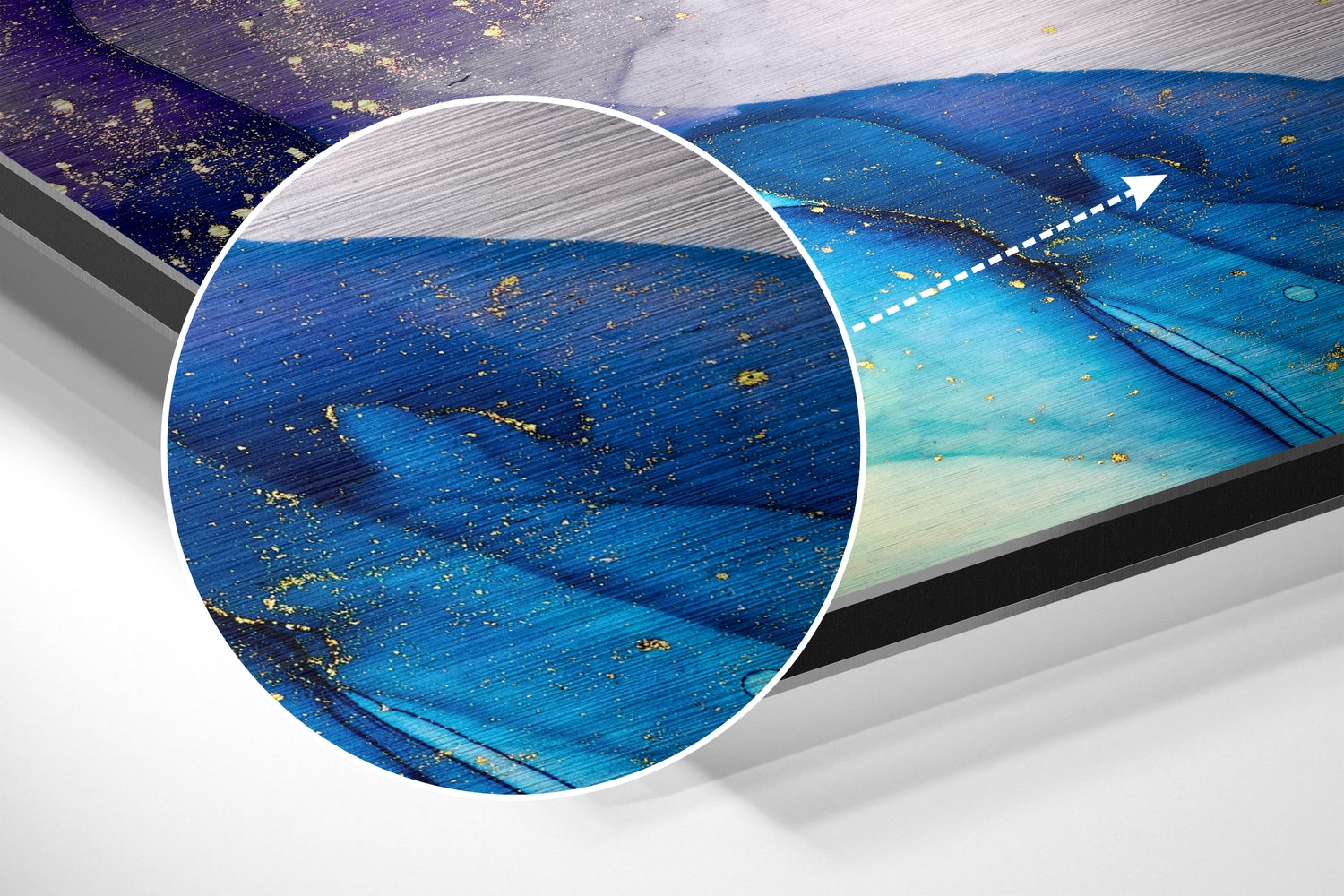 Close-up detail of brushed blue and purple aluminum surface with gold leaf accents and magnified circular view showing texture.